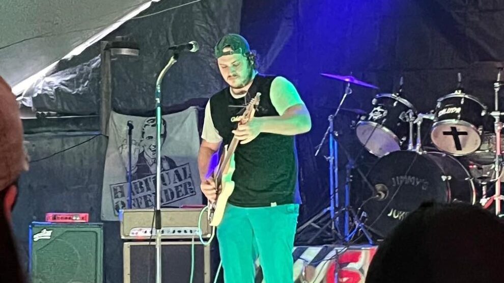 DJ PeanutButter performing live on guitar